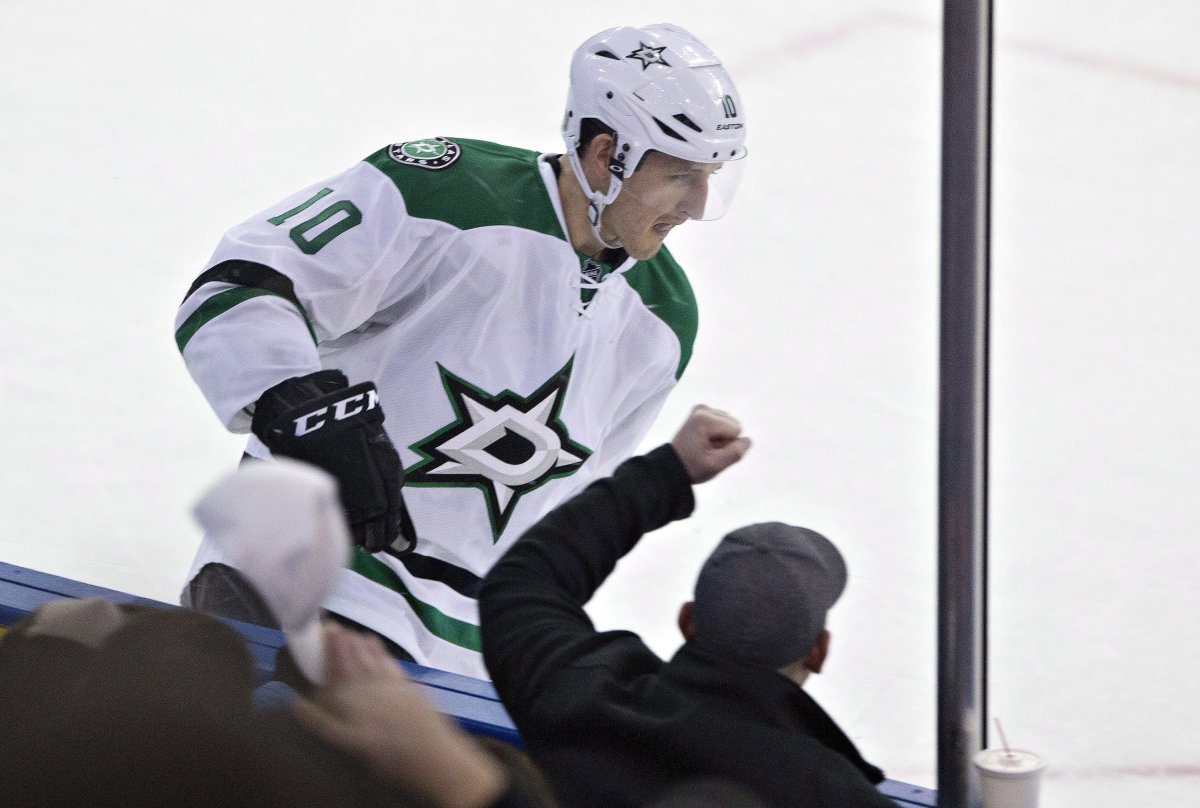 A fan cheers for Dallas Stars' Shawn Horcoff  after he scores against the Edmonton Oilers during a shoot out, Sunday December 21, 2014. 