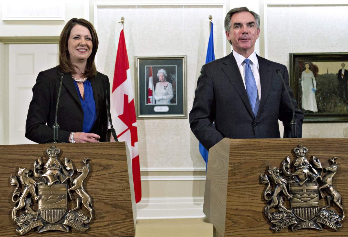Alberta Premier Jim Prentice and former Wildrose Leader Danielle Smith speak to media after a caucus meeting in Edmonton Alta., Wednesday, December 17, 2014. Prentice’s caucus met to discuss a bid by at least half the official Opposition to cross the floor.