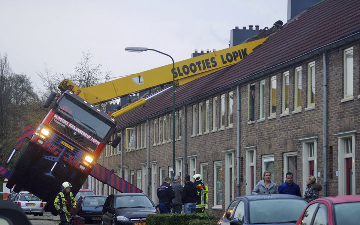 A crane which crashed into the roof of a house is seen following an unusual marriage proposal by a man who wished to be lifted in front of the bedroom window of his girlfriend to ask for her hand in marriage, in the central Dutch town of IJsselstein, Saturday Dec. 13, 2014.