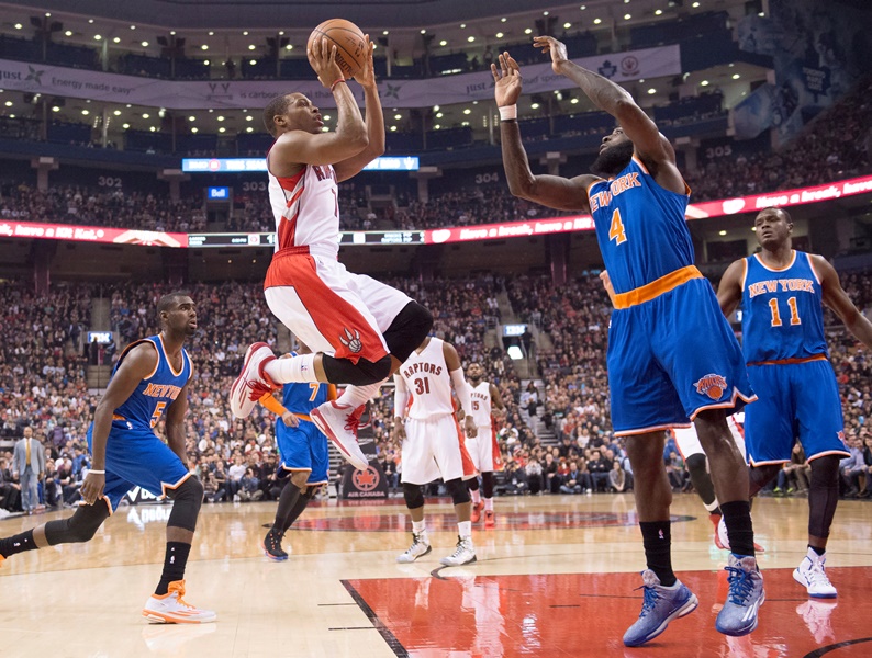 Toronto Raptors guard Kyle Lowry (7) soars to the hoop against New York Knicks forward Quincy Acy (4) during first half NBA action in Toronto Sunday December 21, 2014. 