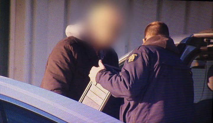 Uniformed and plainclothes RCMP officers remove computers from Caspian Projects in Winnipeg on Wednesday, December 17, 2014.
