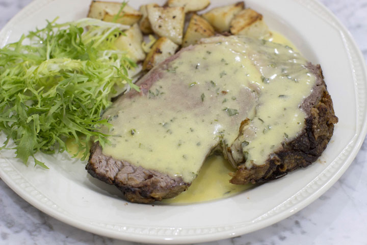 This Nov. 17, 2014 photo shows slow roasted standing rib roast with bearnaise sauce in Concord, N.H. (AP Photo/MatthewMead)This Nov. 17, 2014 photo shows slow roasted standing rib roast with bearnaise sauce in Concord, N.H. The reduction for the bearnaise sauce can be made while the roast is in the oven, then finished when the meat is resting.