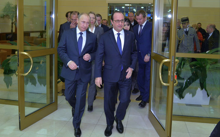 Russian President Vladimir Putin, left, and French President Francois Hollande walk after their meeting at Moscow's Vnukovo airport, Saturday, Dec. 6, 2014. 