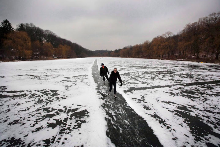 A couple skates along a path in the snow on Grenadier Pond in Toronto's High Park on December 29, 2010. Plunging temperatures will soon make way for frozen-over waterways and community rinks, giving skating enthusiasts a chance to lace 'em up for another season.