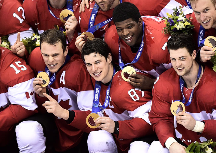 Team Canada captain Sidney Crosby, centre, poses for their team photo after defeating Sweden during third period finals hockey action at the 2014 Sochi Winter Olympics in Sochi, Russia on Sunday, February 23, 2014. 