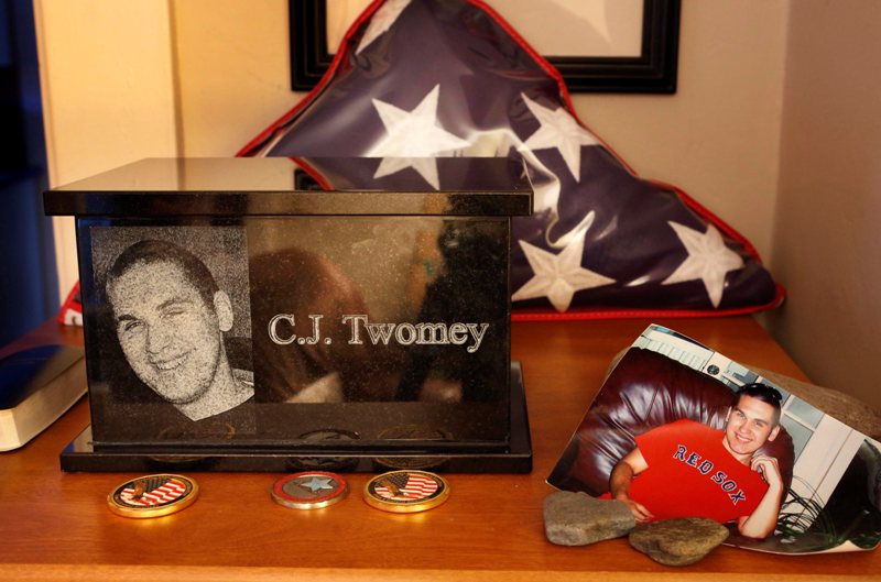 This Dec. 17, 2013, photo shows an urn containing the ashes of C.J. Twomey on a shelf at his parent's home in Auburn, Maine. C.J.'s mother, Hallie Twomey, is asking people to help scatter his ashes throughout the world so he can become part of the world he never got to see. 
