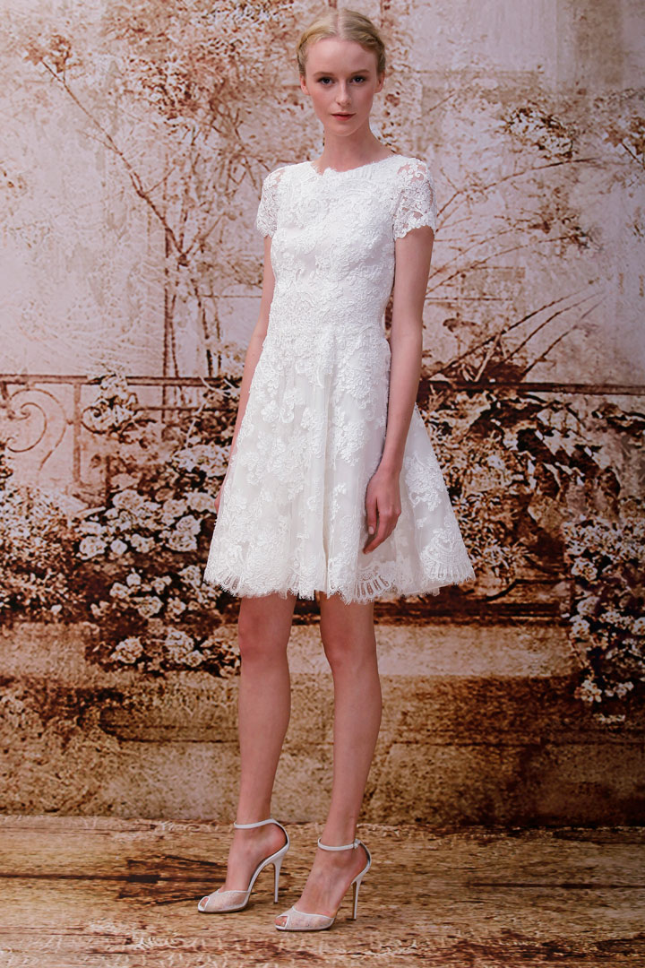 This 2013 image released by the Monique Lhuillier fashion house shows the Opal, a silk white re-embroidered lace short-sleeved mini-wedding dress. "A lot of people are doing more intimate settings, so a shorter dress just feels more appropriate. If they do the big wedding, some change into a shorter dress so they can dance and have a good time," designer Monique Lhuillier said.