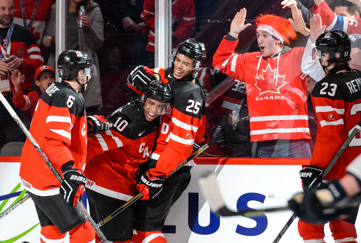 Anthony Duclair of Team Canada celebrates his goal with teammates Shea Theodore and Darnell Nurse during the 2015 IIHF World Junior Hockey Championship game against Team Slovakia at the Bell Centre on December 26, 2014 in Montreal, Quebec.  