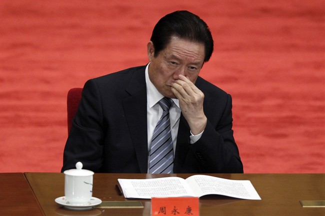 In this photo taken May 4, 2012, Zhou Yongkang, Chinese Communist Party Politburo Standing Committee member in charge of security, attends a conference to celebrate the 90th anniversary of the founding of Chinese Communist Youth League at the Great Hall of the People in Beijing. (AP Photo/Alexander F. Yuan, File).