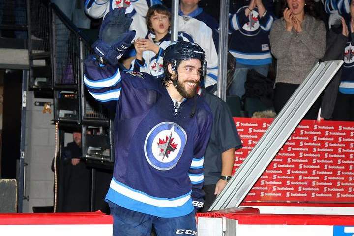 Mathieu Perreault of the Winnipeg Jets waves to the crowd after scoring four goals in the Jets' 8-2 victory over the Florida Panthers on Tuesday at the MTS Centre. Perreault was named the first star of the game.