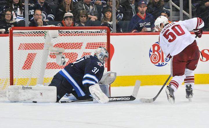 Jets goaltender Ondrej Pavelec makes a pad save on Antoine Vermette of the Arizona Coyotes during the shootout on Sunday at the MTS Centre in Winnipeg. The Jets defeated the Coyotes 4-3.