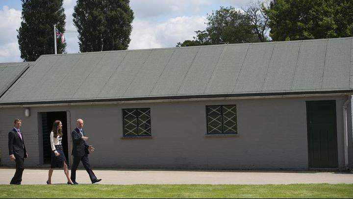 Catherine, Duchess Of Cambridge walks past one of the huts which the 'code-breakers' used as she tours the of the restored WWII Codebreaking Huts at Bletchley Park on June 18, 2014 in Bletchley, England. The pre-fabricated wooden huts that housed the secret Government code breaking school during WWII, where encrypted messages sent by the Navy, Army and Air Forces of Germany and its allies were decrypted, translated and analysed for vital intelligence, have undergone a year long restoration.