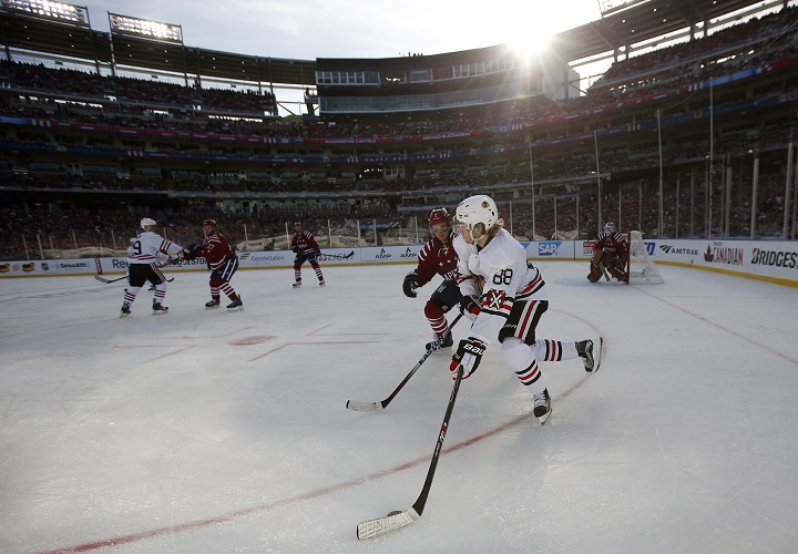 Chicago Blackhawks right wing Patrick Kane (88) skates with the puck as he is covered by Washington Capitals defenseman Matt Niskanen in the first period of the Winter Classic outdoor NHL hockey game at Nationals Park, Thursday, Jan. 1, 2015 in Washington.