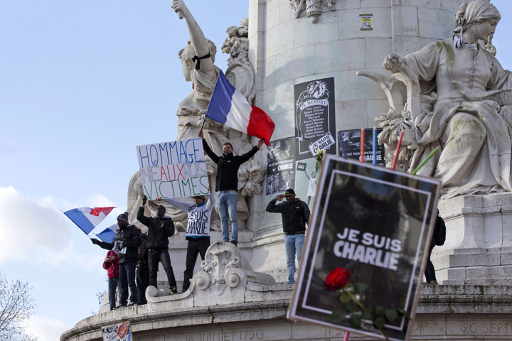 Protesters wave French flags at Republique square in Paris on Jan. 11, 2015.
