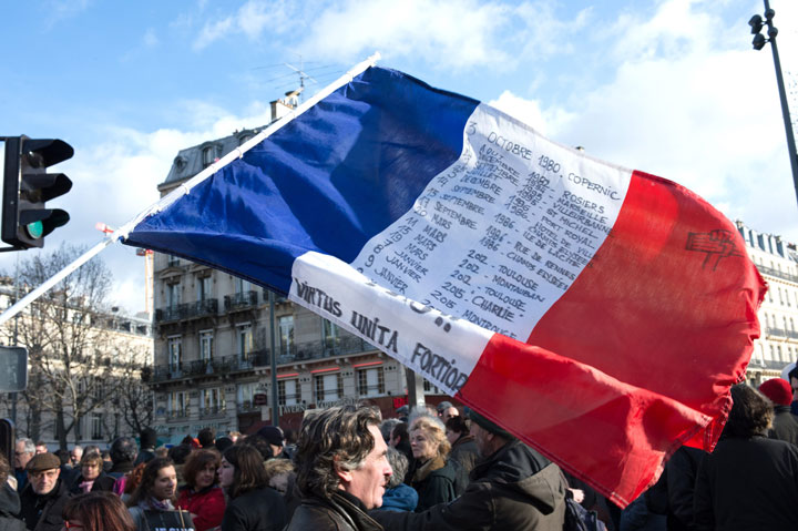 A French flag waves at place de la République in Paris before the march in honour of the Paris shootings victims, on Jan. 11, 2015.