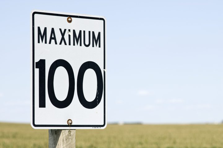 A 100 kilometer an hour speed limit sign on a highway in rural Alberta. 