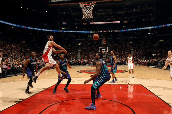  Greivis Vasquez #21 of the Toronto Raptors passes the ball against the Charlotte Hornets on January 8, 2015 at the Air Canada Centre in Toronto, Ontario, Canada.