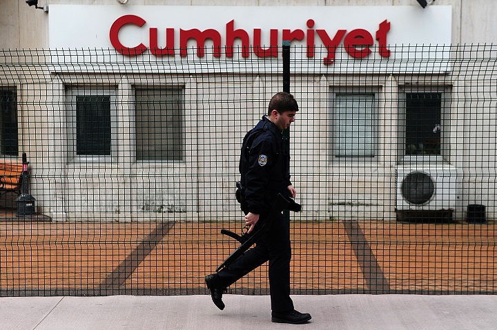 An armed police officer walks of the Cumhuriyet daily newpaper building on January 14, 2015 in istanbul.  The daily Cumhuriyet, which strongly opposes President Recep Tayyip Erdogan, printed a four page pull-out containing cartoons and articles translated into Turkish from the latest edition of French satirical magazine Charlie Hebdo. 