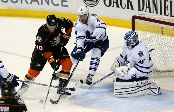 Corey Perry #10 of  the Anaheim Ducks fights for the puck in front of the net against Cody Franson #4 and goalie Jonathan Bernier #45 of the Toronto Maple Leafs at Honda Center on January 14, 2015 in Anaheim, California.  The Ducks won 4-0. 
