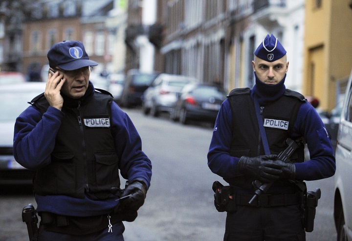 Policemen stand guard at Colline street in Verviers, eastern Belgium, on January 16, 2015, after police shot dead two suspects in a gun battle after they opened fire on officers with heavy weapons, and arrested a third man. Belgium was on high alert after two suspected jihadists were killed in a police raid, while German and French police made fresh arrests to put Europe on edge a week after the Islamist attacks in Paris. 
