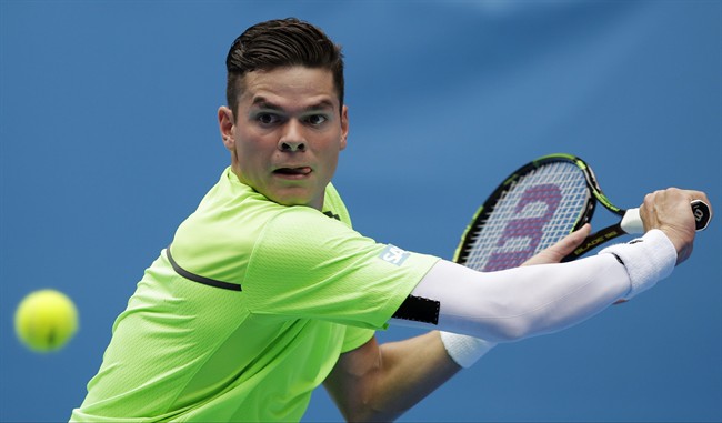 Milos Raonic eyes the ball for a shot to Illya Marchenko of Ukraine during their first round match at the Australian Open tennis championship in Melbourne, Australia, Tuesday, Jan. 20, 2015.