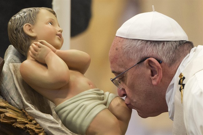 Pope Francis kisses a statue of the baby Jesus on New Year's Day in Vatican City.