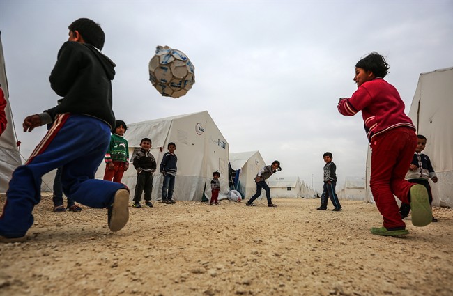 Syrian refugee children who fled violence in Syrian play outside their tent in the border town of Suruc, Turkey.