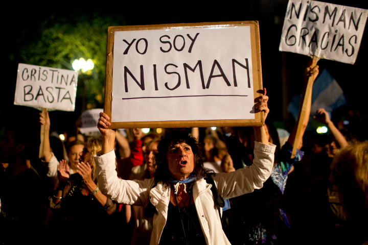 A demonstrator holds a sign that reads in Spanish "I am Nisman" during a protest sparked by the death of special prosecutor Alberto Nisman, outside the government house in Plaza de Mayo in Buenos Aires, Argentina, Monday, Jan. 19, 2015. 