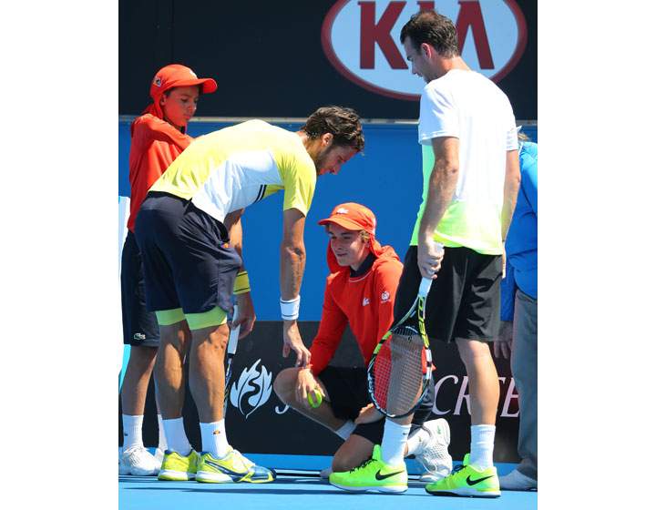 Feliciano Lopez of Spain speaks to a ball kid that got struck by a serve in his second round match against Adrian Mannarino of France during day four of the 2015 Australian Open at Melbourne Park on January 22, 2015 in Melbourne.