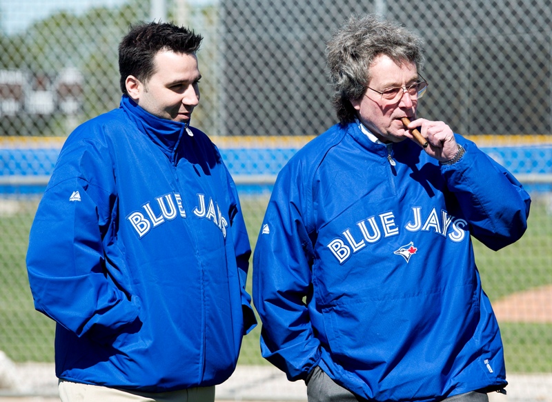 Toronto Blue Jays President and CEO Paul Beeston, right, and general manager Alex Anthopoulos talk as they watch the Blue Jays during baseball spring training in Dunedin, Fla., on Sunday, Feb. 17, 2013. 