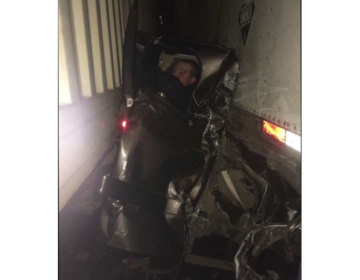 Man walks away from crash after being pancaked between trucks - image