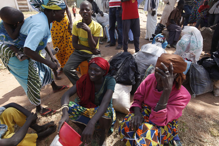 People who have fled their Nigerian villages after attacks by Boko Haram sit in a camp for internal displaced people in November, 2014.