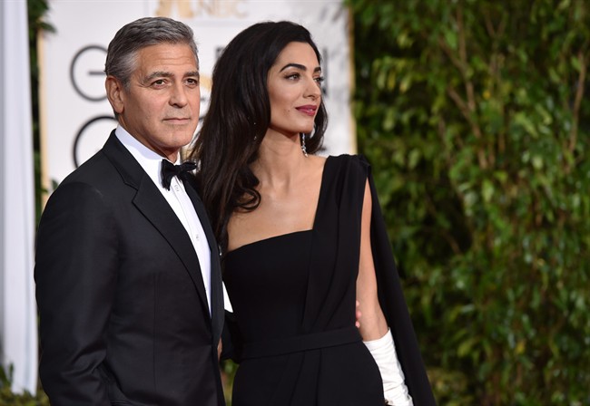 George Clooney, left, and Amal Clooney arrive at the 72nd annual Golden Globe Awards at the Beverly Hilton Hotel on Sunday, Jan. 11, 2015, in Beverly Hills, Calif.