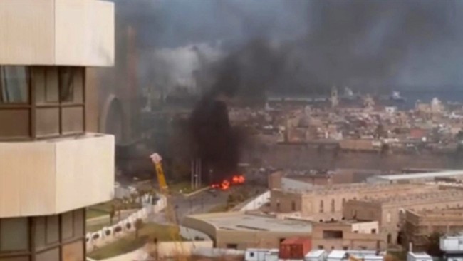 In this image made from video posted by a Libyan blogger, the Cortinthia Hotel is seen under attack in Tripoli, Libya, Tuesday, Jan. 27, 2015.