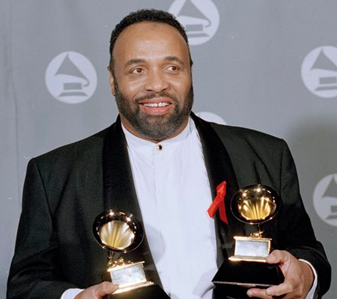 FILE - In this March 1, 1995 file photo, Andrae Crouch displays his two Grammys backstage at the 37th annual Grammy Awards at the Shrine Auditorium in Los Angeles. Crouch, a legendary gospel performer, songwriter and choir director whose work graced songs by Michael Jackson and Madonna and movies such as “The Lion King,” has died at age 72. 