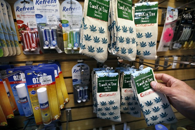 In this Jan. 27, 2015 photo, marijuana-themed souvenir socks sold by entrepreneur Ann Jordan are stocked alongside various items by Arnie Slaughter, the owner of the Red Carpet Car Wash and Detailing, in Aurora, Colo. 