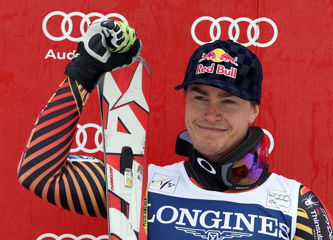 Erik Guay celebrates on the podium after winning an alpine ski men's World Cup downhill, in Kvitfjell, Norway, on March 1, 2014.