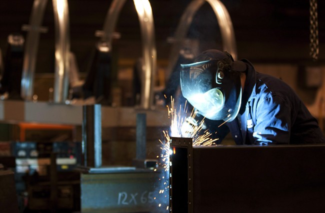 A welder works in a factory in Quebec City, Tuesday, February 28, 2012.