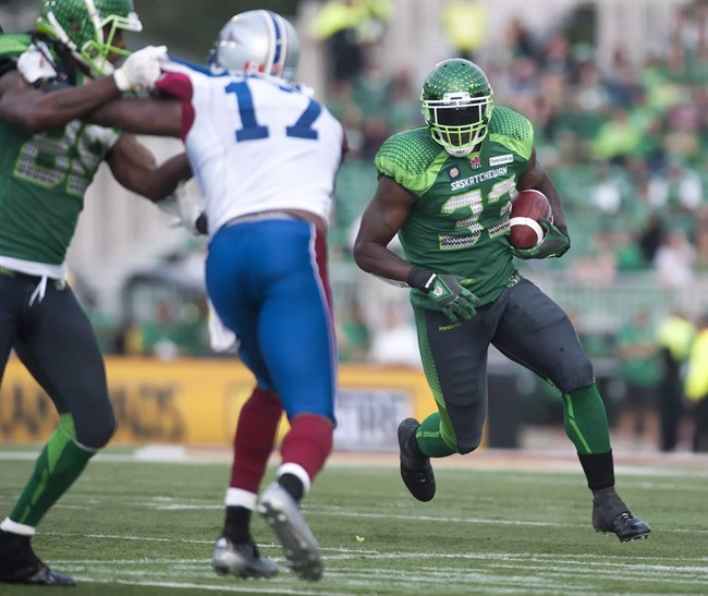 Saskatchewan Roughriders running back Jerome Messam runs the ball against the Montreal Alouettes during the fourth quarter of CFL football action in Regina on August 16, 2014. Less automatic converts, more space for receivers are some of rule changes proposed for 2015 CFL season.