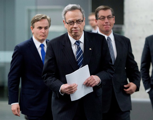 Finance Minister Joe Oliver, middle, makes his way to the podium with Minister of State (Finance) Kevin Sorenson, right, and Parliamentary Secretary to the Finance Minister, Andrew Saxton prior to the finance ministers meeting in Ottawa on Monday, Dec. 15, 2014.