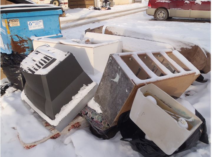 Garbage sits outside a dumpster in north Edmonton.