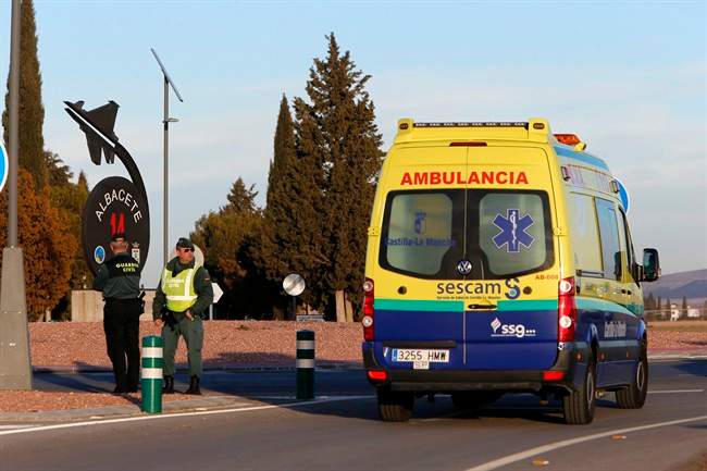 An ambulance drives past one of the entrances of a military base after a plane crash in Albacete, Spain, Monday, Jan. 26, 2015. (AP Photo/Josema Moreno).