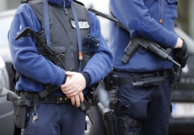 Armed Belgian police officers guard a street in Verviers, Belgium, Friday, Jan. 16, 2015.