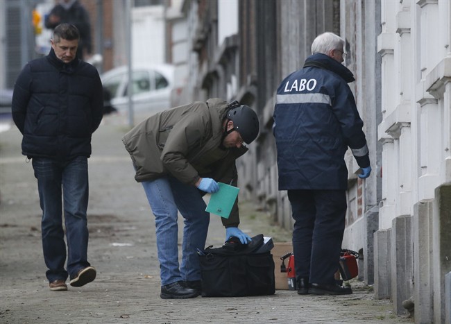Belgian police officers examine a house in Verviers, Belgium, Friday, Jan. 16, 2015. Police in several European countries have stepped up security since the attack on the Paris magazine Charlie Hebdo earlier in January.