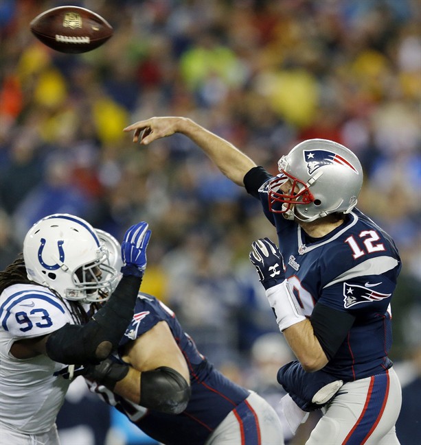 New England Patriots quarterback Tom Brady passes over Indianapolis Colts outside linebacker Erik Walden (93) during the first half of the NFL football AFC Championship game Sunday, Jan. 18, 2015,