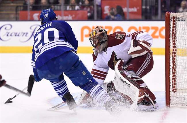 Arizona Coyotes goalie Mike Smith stops Toronto Maple Leafs' David Booth during the second period of an NHL hockey game Thursday, Jan. 29, 2015, in Toronto.