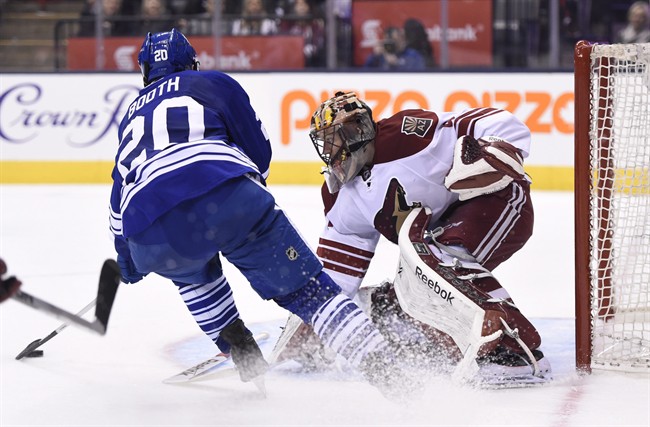 Arizona Coyotes goalie Mike Smith stops Toronto Maple Leafs' David Booth during the second period of an NHL hockey game Thursday, Jan. 29, 2015, in Toronto.