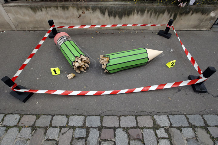 An anonymous art installation showing a broken pencil is displayed on the pavement near the 'Charlie Hebdo' office in Paris, Tuesday, Jan. 20, 2015. 