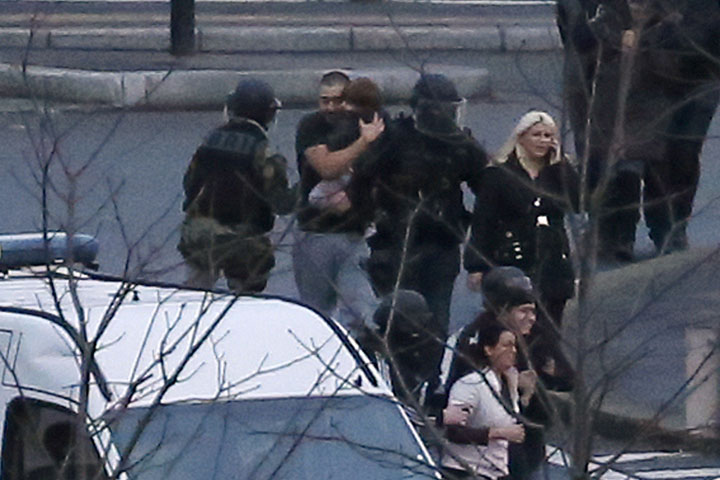 Members of the French police special forces evacuate hostages including a child after launching the assault at a kosher grocery store in Porte de Vincennes, eastern Paris, on January 9.  