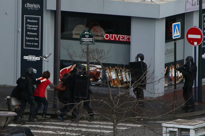 People are led away from the scene as Police mobilize with reports of a hostage situation at Port de Vincennes on January 9, 2015 in Paris, France. 